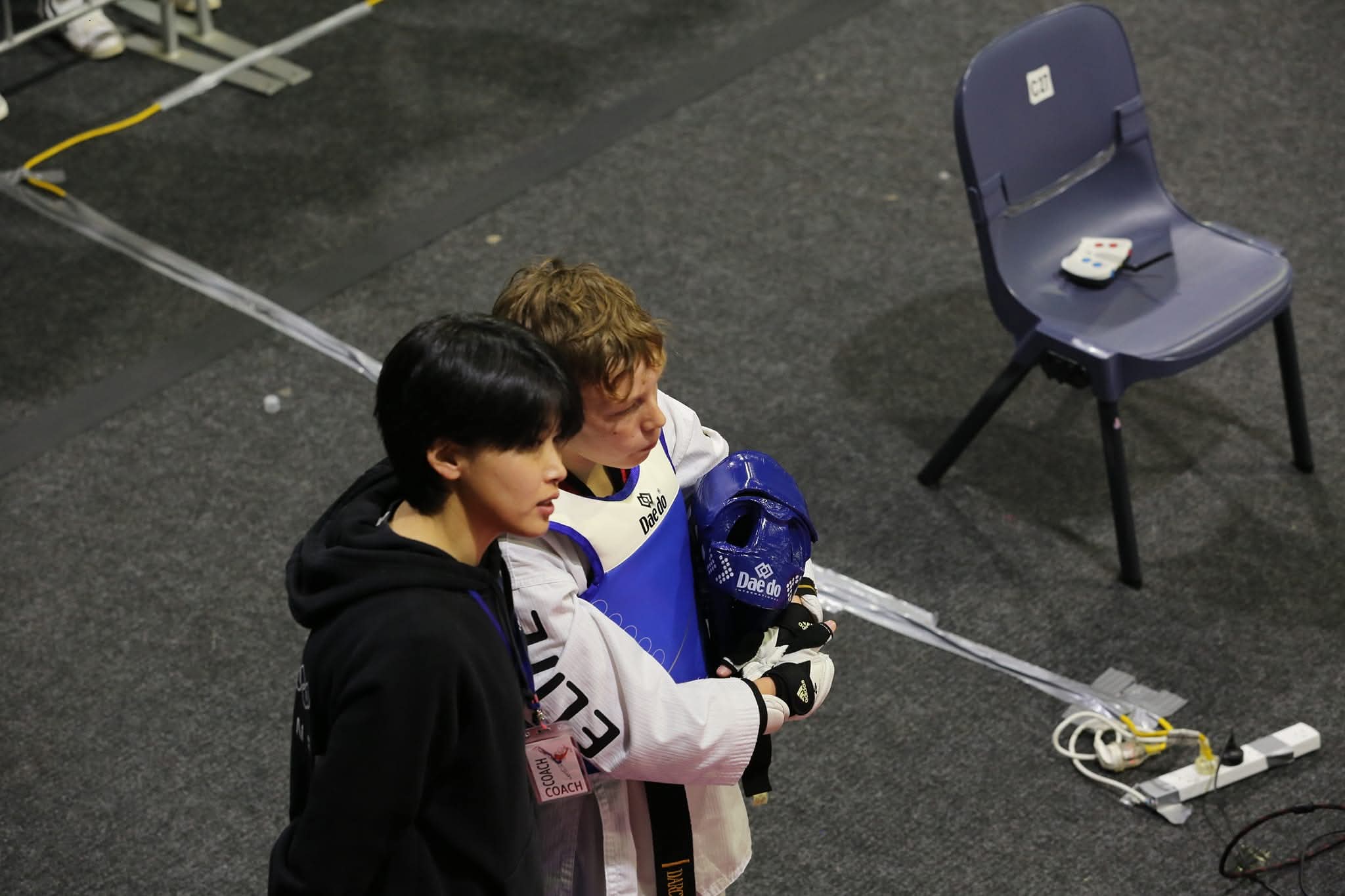 Robin Cheong coaching a young athlete at a competition